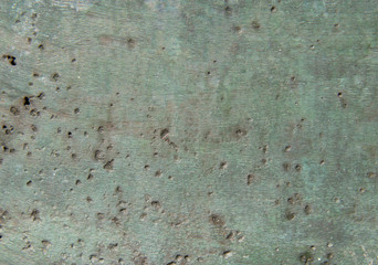 Background of green oxidized bronze with potholes and interspersed .. Texture of oxides on brass