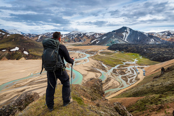 The man hiker looking at the camp in Landmannalaugar, Iceland