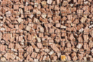 The texture of the gabion fence is made of natural stone and metal mesh