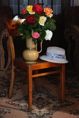 Bouquet of roses on the old chair