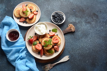 Sweet pancakes served with fresh blueberries , mint, strawberries,organic agave syrup. Healthy breakfast concept