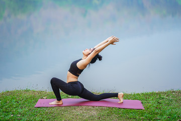 Portrait of young woman practicing yoga outdoor. Beautiful girl practice yoga in nature