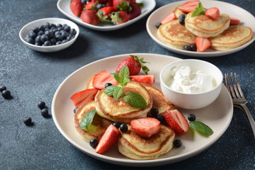 Sweet pancakes served with fresh blueberries , mint, strawberries,organic agave syrup. Healthy breakfast concept
