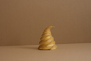 Straw sculptures on a beige background. Decoration. Souvenir