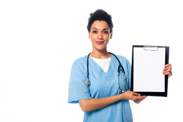 Front view of african american nurse with stethoscope looking at camera and showing clipboard...