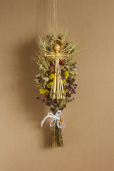 Ukrainian decoration and traditional symbol. Made of straw of different cereals and flowers. Angel is made of straw