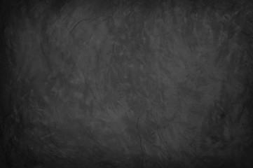 Dark concrete textured wall background.black grunge cement wall texture for interior design. dark edges.copy space for add text.