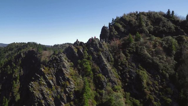 Pivoting on hikers atop Charlies Bunion this aerial view lifts up to reveal the great smoky mountain cinematic landscape