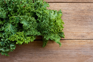 Kale cabbage vegetable leaf isolated on wood table background.