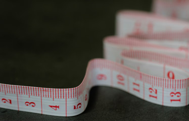 Close up view of tailor measuring tape on black background