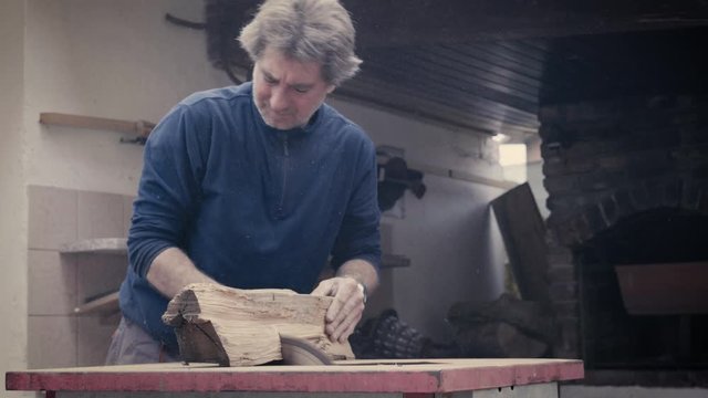 slow motion od a carpenter cutting woods with a circular saw