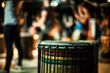 A creative close up shot with shallow depth of field on an African doun doun drum in a music bar by...