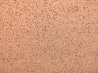 Texture of the pink plaster bark beetle on the wall. Seamless texture.