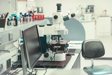 Fototapeta na wymiar Microscope with metal lens at laboratory for developing vaccines against coronavirus