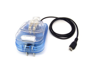 Transparent blue mobile phone charger with USB cable isolated on white background. Battery charger. Wall charger. USB charger. USB to micro USB cable connector
