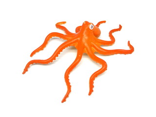 Orange color octopus toy isolated on white background. Artificial octopus. Kids toy. Rubber toy.