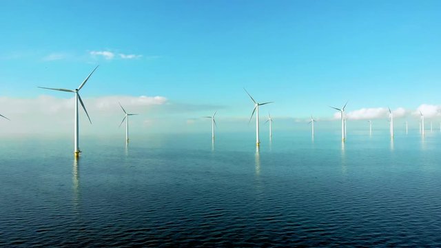 Windmill row of windmills in the ocean by the lake Ijsselmeer Netherlands, renewable energy windmill farm Flevoland