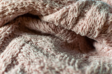 Fine textured and voluminous fabric in pink. Embossed textile pattern, pleasant to the touch and delicate, velvety and textured background for design and decoration.