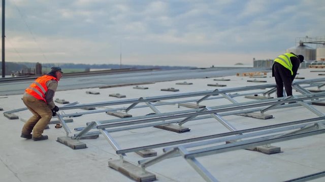 Alternative energy and professional construction. Rooftop solar panel mounting structure installation