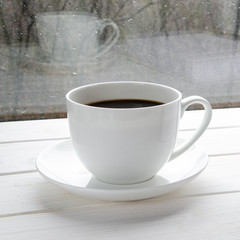 Coffee cup over mirror background in rainy day,copy space
