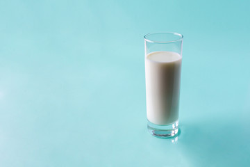 glass of milk on light blue background