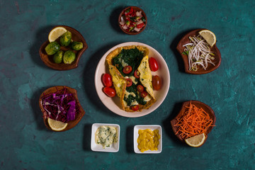 An omelet with spinach, tomatoes and cheese