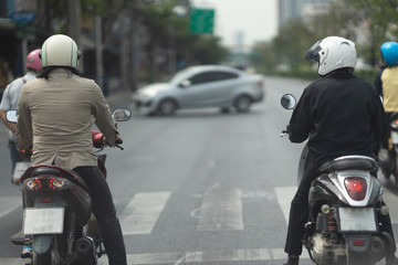 Fototapeta na wymiar Two motorcycles on waiting zebra crossing traffic road