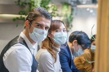 Group of business people workers talking together with laptop and wear protective masks prevent PM...