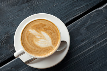 latte coffee top view on vintage dark grey wooden table background