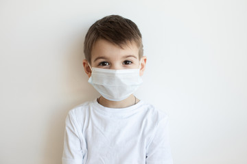 Concept of coronavirus quarantine. Child in mask . Protection against virus, infection. Health....