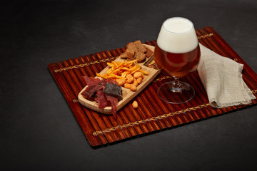Glass with beer and snacks