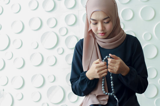 young muslim woman dressed in black hijab, praying for Allah, copy space. concept Religious rituals for peace