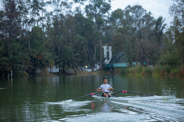 Fototapeta na wymiar rowing men on lake
