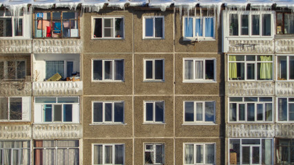 Soviet apartment buildings. Ust-Kamenogorsk (Kazakhstan). Apartment blocks. Soviet architectural style. Winter icicles