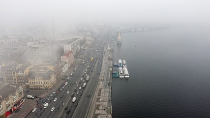 A city covered in fog. City traffic, aerial view