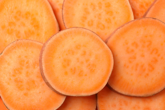 Sweet potato slices on whole background, close up. Vegetables