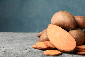 Sweet potato on grey table, close up. Vegetables