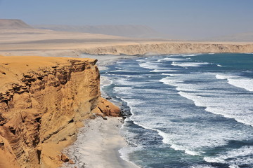 The waves of the Pacific Ocean wash the rocky shore. Peninsula Paracas. Peru.