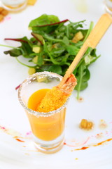 Shrimp in breadcrumbs with mango sauce on a white plate