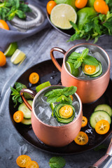 Moscow mule cocktail with lime, mint, cucumber and kumquat