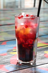 Berry-citrus cocktail on a white isolated background