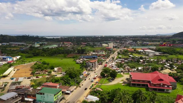 Road and streets in the town of Tacloban, Philippines. Car traffic, top view. Cityscape in the asian town. Summer and travel vacation concept.