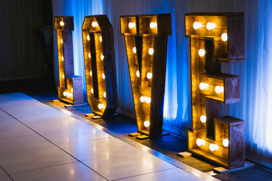 Wooden letters with small lamps, love sign lighting with bulb lights