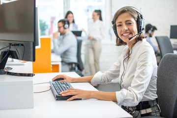 Professional helpline call center agent operator woman wearing headset working in customer care...