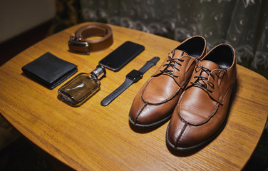 different accessories of a businessman for creating a style of a people lie on a wooden background