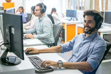 Customer support operators working together in call center