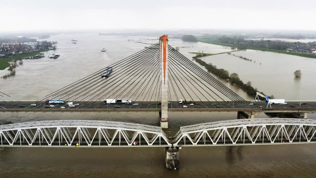 Zaltbommel, Noord-Brabant / The Netherlands - March 17th 2020: Train, ship and cars, all forms of mobility, at the Martinus Nijhoffbrug over the Waal