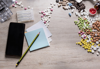 checking medications and patient care. Table with pills and a sticker for writing.