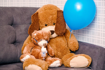 Child makes the procedure to toy, Teddy Bear with an inhaler - nebulizer. Inhalation at home for cough health, allergy,