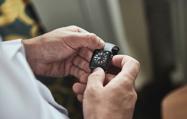 businessman checking time on his wrist watch, man putting clock on hand,groom getting ready in the morning before wedding ceremony. Men Fashion
